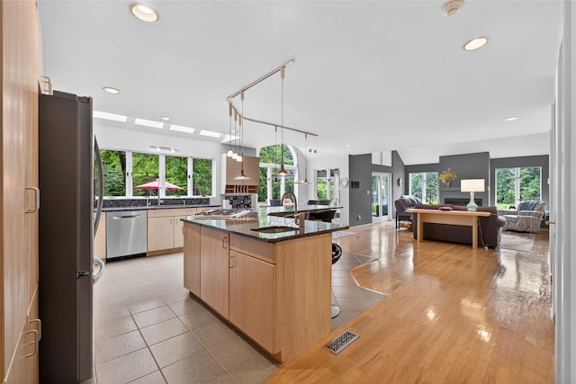 109 Sleight Plass Rd, Poughkeepsie, NY 12603 - kitchen featuring appliances with stainless steel finishes, light brown cabinets, plenty of natural light, recessed lighting, and dark stone countertops