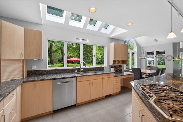 109 Sleight Plass Rd, Poughkeepsie, NY 12603 - kitchen with appliances with stainless steel finishes, a skylight, light brown cabinets, lofted ceiling, and plenty of natural light