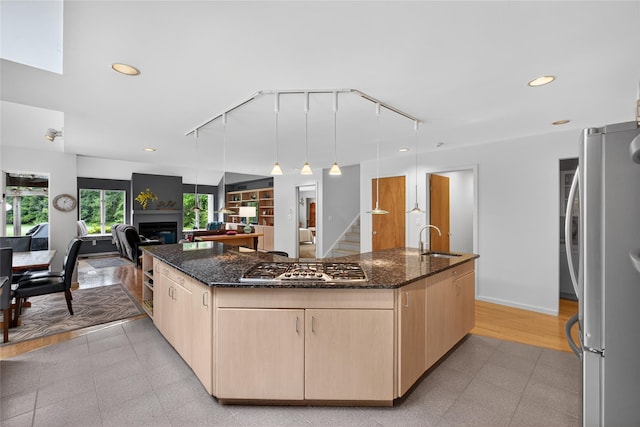 109 Sleight Plass Rd, Poughkeepsie, NY 12603 - kitchen with appliances with stainless steel finishes, light brown cabinetry, track lighting, a spacious island, and dark stone countertops