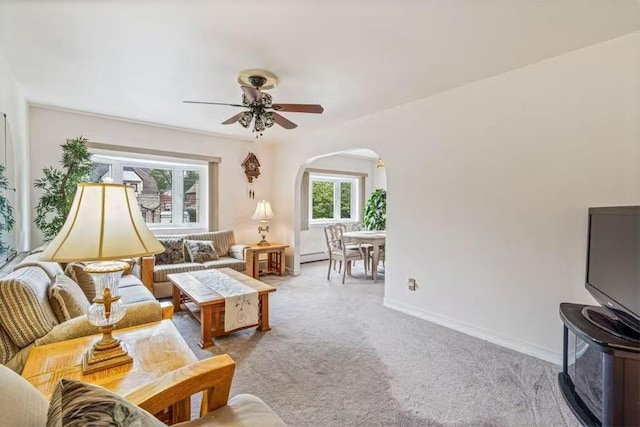 3226 165th St, Flushing, NY 11358 - living area with arched walkways, carpet floors, ceiling fan, baseboard heating, and baseboards