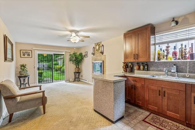 3226 165th St, Flushing, NY 11358 - kitchen with a baseboard radiator, a sink, a ceiling fan, backsplash, and light countertops