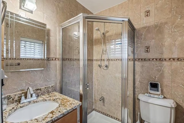 3226 165th St, Flushing, NY 11358 - bathroom with tile walls, vanity, a shower stall, and toilet