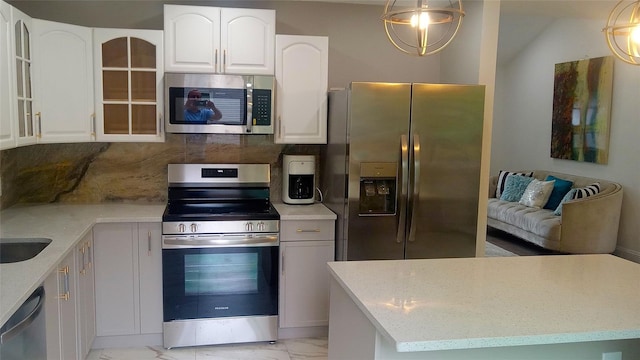 34 Park Ln, Medford, NY 11763 - kitchen with stainless steel appliances, light marble finish flooring, glass insert cabinets, backsplash, and light stone counters