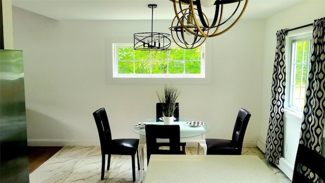 34 Park Ln, Medford, NY 11763 - dining room with a chandelier, marble look tiles, baseboards, and a baseboard heating unit