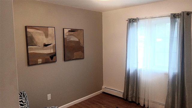 34 Park Ln, Medford, NY 11763 - empty room with dark wood-style floors, a baseboard heating unit, and baseboards