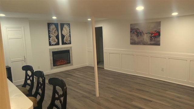 34 Park Ln, Medford, NY 11763 - finished basement featuring recessed lighting, dark wood-style flooring, a tiled fireplace, a wainscoted wall, and a decorative wall
