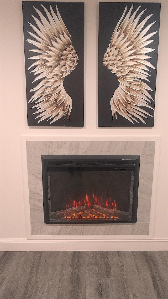 34 Park Ln, Medford, NY 11763 - detailed view of a tiled fireplace, wood finished floors, and baseboards