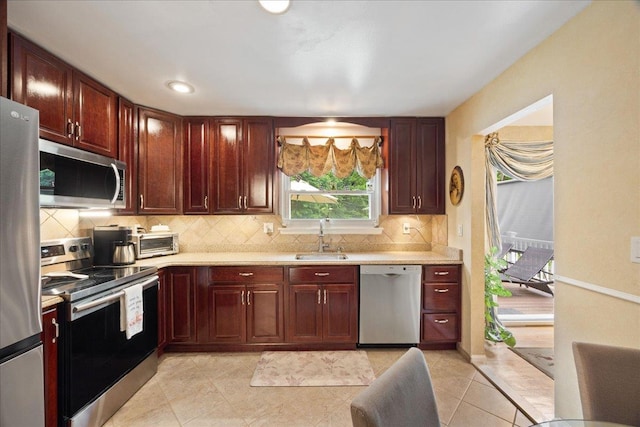 550 Saw Mill River Rd, Millwood, NY 10546 - kitchen with appliances with stainless steel finishes, a sink, light countertops, backsplash, and reddish brown cabinets