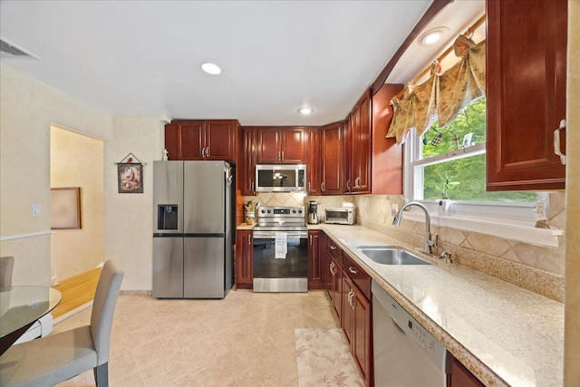 550 Saw Mill River Rd, Millwood, NY 10546 - kitchen featuring stainless steel appliances, a sink, light countertops, backsplash, and light tile patterned floors