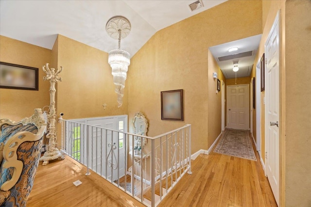 550 Saw Mill River Rd, Millwood, NY 10546 - corridor with attic access, wood finished floors, an upstairs landing, baseboards, and a chandelier