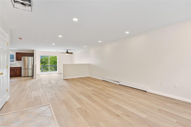 221 Tamerisk Ln, New Windsor, NY 12553 - unfurnished living room featuring baseboard heating, light wood-style flooring, ceiling fan, recessed lighting, and baseboards