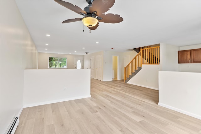 221 Tamerisk Ln, New Windsor, NY 12553 - unfurnished living room with a baseboard radiator, light wood-style flooring, baseboards, recessed lighting, and stairway