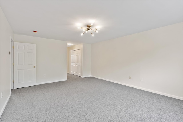 221 Tamerisk Ln, New Windsor, NY 12553 - spare room featuring carpet flooring, baseboards, and a chandelier