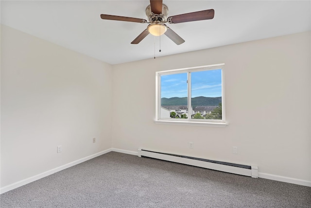221 Tamerisk Ln, New Windsor, NY 12553 - carpeted spare room with a baseboard radiator, baseboards, a ceiling fan, and a mountain view