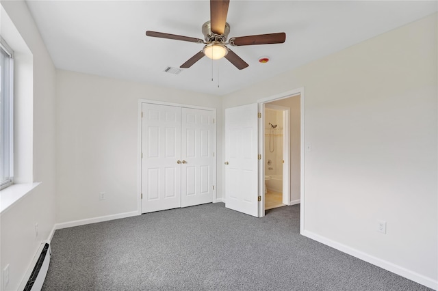 221 Tamerisk Ln, New Windsor, NY 12553 - unfurnished bedroom featuring a baseboard radiator, dark colored carpet, baseboards, a closet, and a ceiling fan