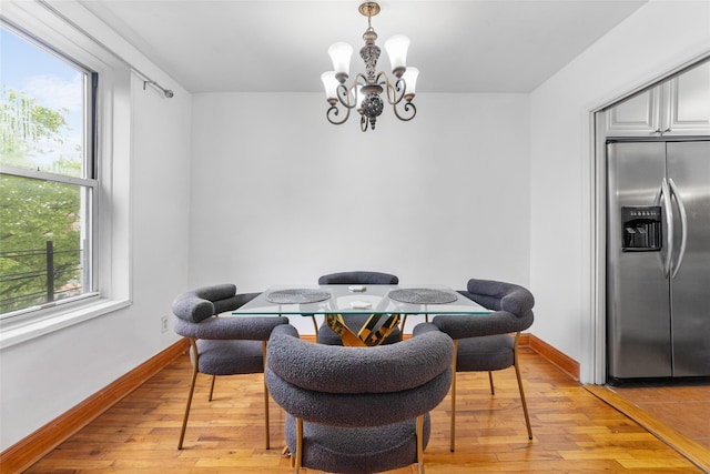 59-30 108th St Unit 6K, Corona, NY 11368 - dining space with a chandelier, light wood-type flooring, and baseboards