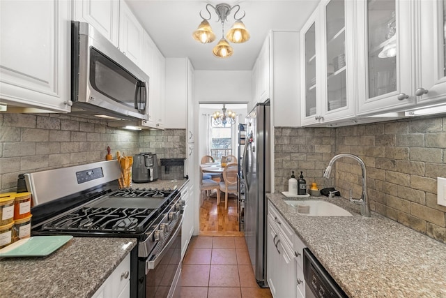 59-30 108th St Unit 6K, Corona, NY 11368 - kitchen with appliances with stainless steel finishes, a chandelier, a sink, and white cabinetry