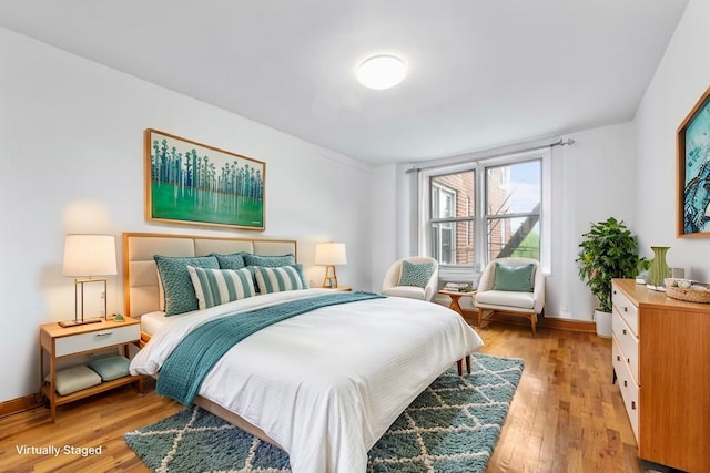 59-30 108th St Unit 6K, Corona, NY 11368 - bedroom featuring light wood-style flooring and baseboards