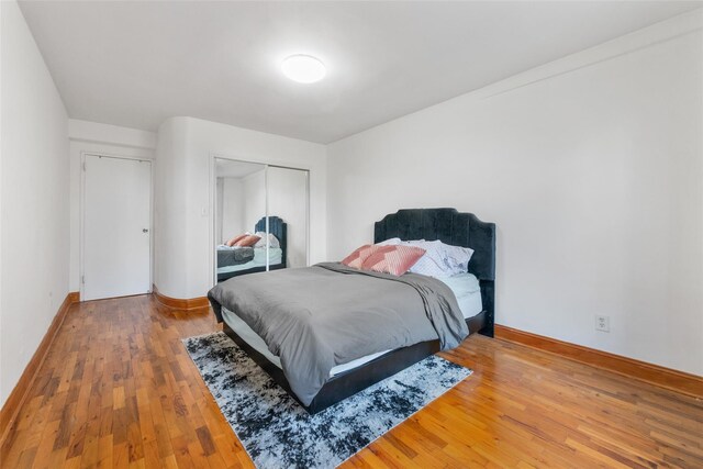 59-30 108th St Unit 6K, Corona, NY 11368 - bedroom featuring a closet, wood-type flooring, and baseboards
