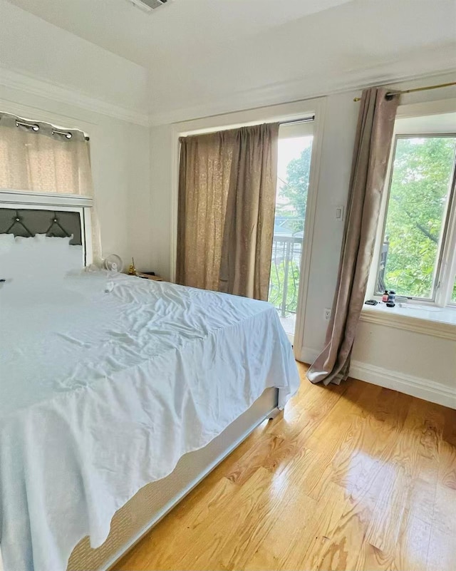 11516 14th Ave, College Point, NY 11356 - bedroom with access to exterior, light wood finished floors, and baseboards
