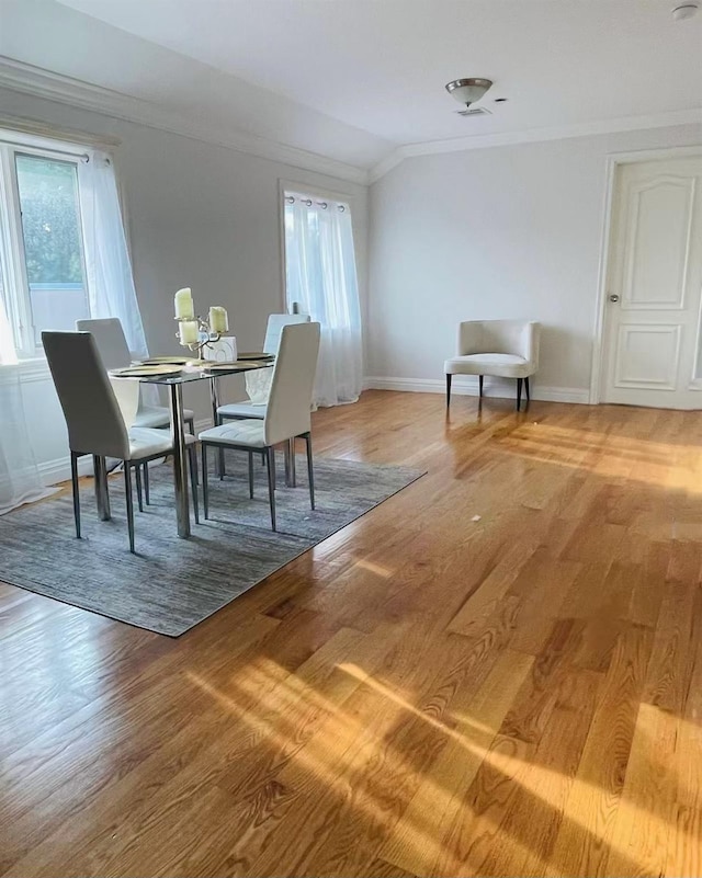 11516 14th Ave, College Point, NY 11356 - dining area with crown molding, healthy amount of natural light, baseboards, and light wood finished floors