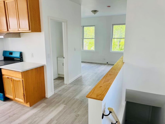 1372 E 94th St, Brooklyn, NY 11236 - kitchen featuring stainless steel electric range oven, light wood-style floors, light countertops, and brown cabinetry