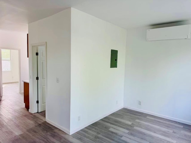 1372 E 94th St, Brooklyn, NY 11236 - spare room featuring a wall mounted air conditioner, wood finished floors, electric panel, and baseboards