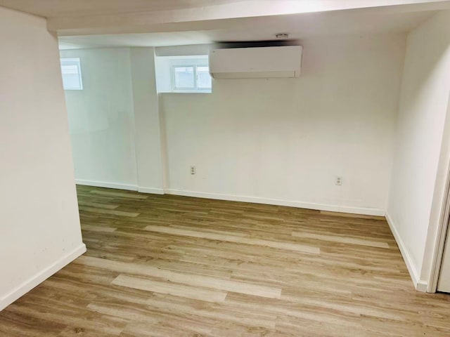 1372 E 94th St, Brooklyn, NY 11236 - basement featuring a wall mounted air conditioner, wood finished floors, and baseboards
