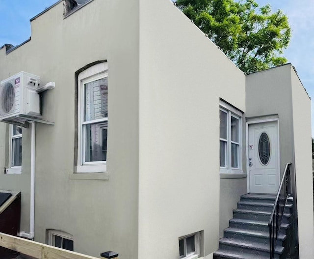 1372 E 94th St, Brooklyn, NY 11236 - view of side of property featuring entry steps, stucco siding, and ac unit