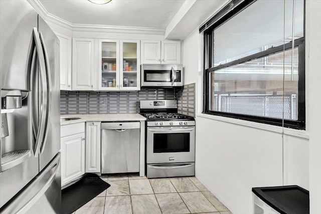 4705 Henry Hudson Pkwy W Unit 7F, Bronx, NY 10471 - kitchen with appliances with stainless steel finishes, white cabinets, light countertops, glass insert cabinets, and decorative backsplash