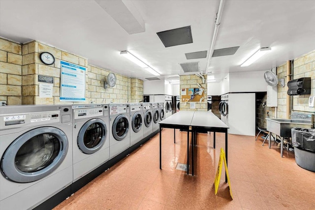 4705 Henry Hudson Pkwy W Unit 7F, Bronx, NY 10471 - community laundry room with tile patterned floors, stacked washer / dryer, and washing machine and clothes dryer