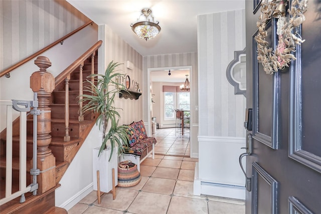 285 Willow Grove Rd, Stony Point, NY 10980 - entrance foyer with wallpapered walls, stairway, light tile patterned floors, baseboards, and a chandelier