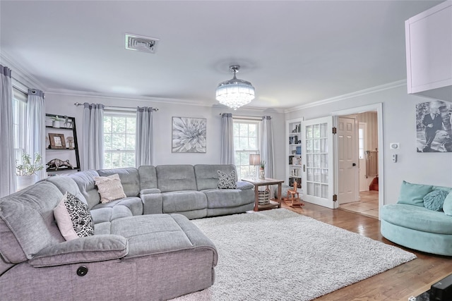 285 Willow Grove Rd, Stony Point, NY 10980 - living room featuring ornamental molding, plenty of natural light, wood finished floors, and a chandelier