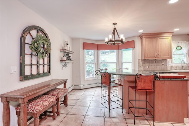 285 Willow Grove Rd, Stony Point, NY 10980 - kitchen with a breakfast bar, a sink, a chandelier, recessed lighting, and decorative backsplash