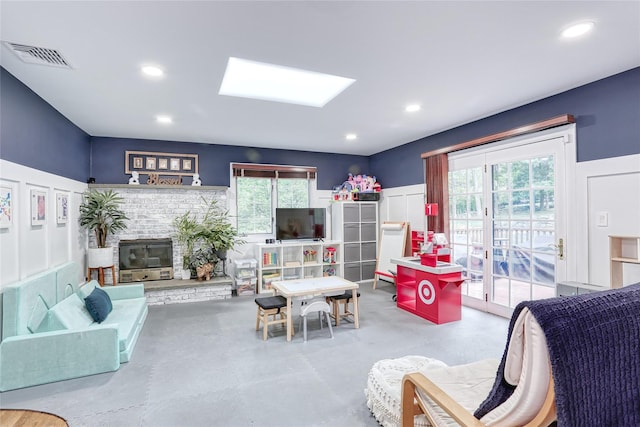 285 Willow Grove Rd, Stony Point, NY 10980 - living room featuring concrete floors, a brick fireplace, recessed lighting, and a skylight