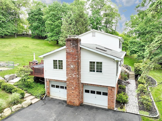 285 Willow Grove Rd, Stony Point, NY 10980 - view of home's exterior with driveway, a garage, a yard, a wooden deck, and brick siding