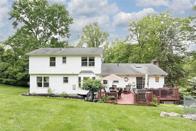 285 Willow Grove Rd, Stony Point, NY 10980 - rear view of house featuring a chimney, a deck, and a lawn