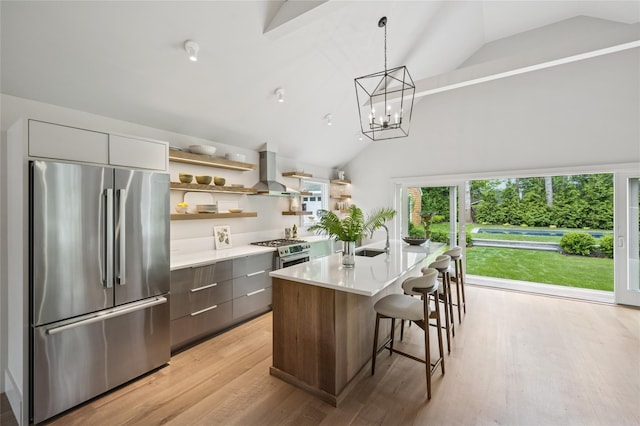69 Bay View Dr W, Sag Harbor, NY 11963 - kitchen featuring stainless steel appliances, wall chimney range hood, open shelves, modern cabinets, and vaulted ceiling