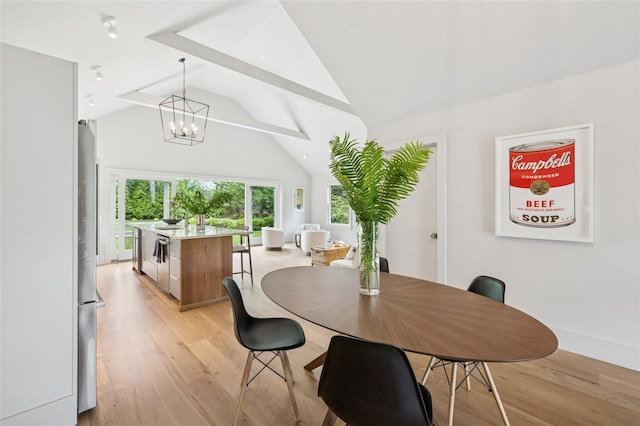 69 Bay View Dr W, Sag Harbor, NY 11963 - dining space featuring light wood-style floors, a chandelier, and high vaulted ceiling