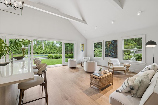 69 Bay View Dr W, Sag Harbor, NY 11963 - living room featuring high vaulted ceiling, beam ceiling, light wood-type flooring, and a chandelier