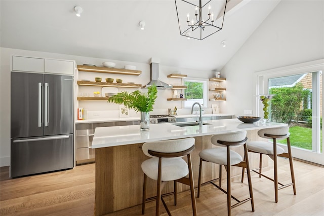 69 Bay View Dr W, Sag Harbor, NY 11963 - kitchen featuring freestanding refrigerator, a sink, wall chimney exhaust hood, open shelves, and light countertops