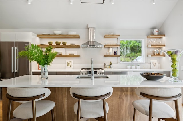 69 Bay View Dr W, Sag Harbor, NY 11963 - bar area with wall chimney exhaust hood, a sink, and high quality fridge