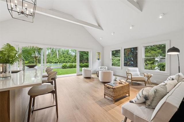 69 Bay View Dr W, Sag Harbor, NY 11963 - living area with high vaulted ceiling, light wood-type flooring, a chandelier, and beamed ceiling