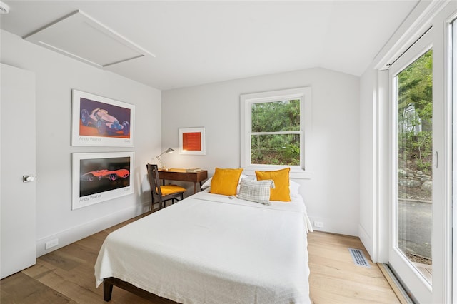69 Bay View Dr W, Sag Harbor, NY 11963 - bedroom featuring multiple windows, attic access, light wood finished floors, lofted ceiling, and access to outside