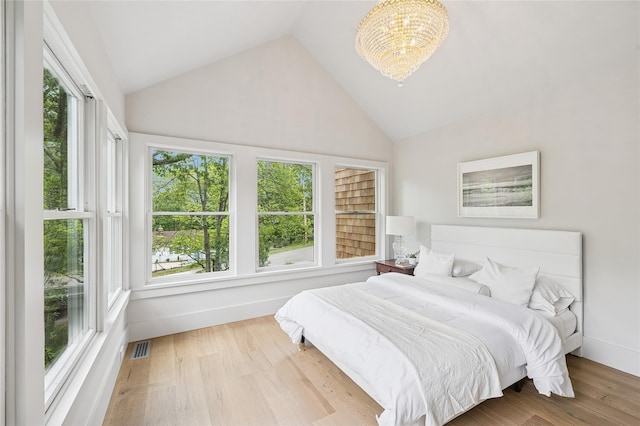 69 Bay View Dr W, Sag Harbor, NY 11963 - bedroom with a chandelier, high vaulted ceiling, and wood finished floors