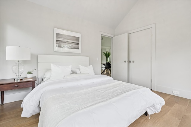 69 Bay View Dr W, Sag Harbor, NY 11963 - bedroom with wood finished floors, vaulted ceiling, a closet, and baseboards