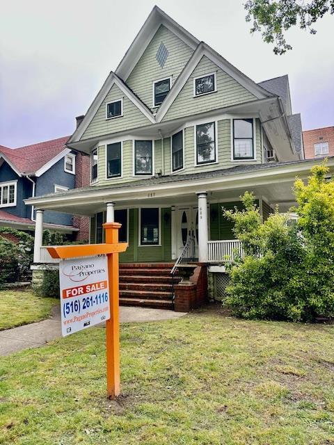 689 E 19th St, Brooklyn, NY 11230 - victorian-style house with a porch and a front lawn