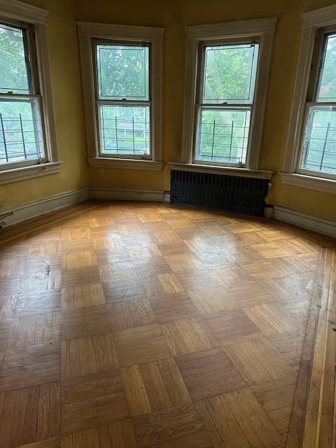 689 E 19th St, Brooklyn, NY 11230 - empty room with radiator heating unit and plenty of natural light