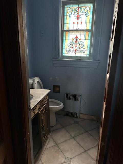 689 E 19th St, Brooklyn, NY 11230 - bathroom with radiator heating unit, vanity, toilet, and tile patterned flooring