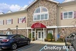 174 Spring Dr Unit 174, East Meadow, NY 11554 - view of building exterior featuring uncovered parking